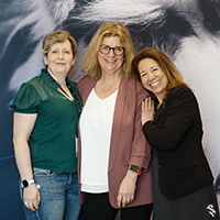 Three people at the APHA Leadership Gathering, smiling.