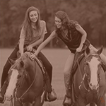 Two APHA members playfully riding their Paint Horses together.