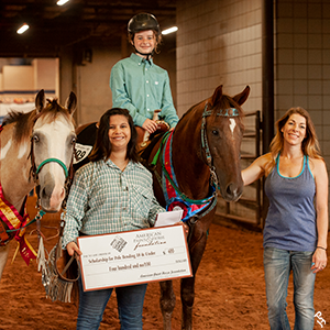 AjPHA member and their family standing proudly with their scholarship check.