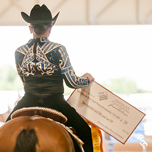 Scholarship recipient riding away with their check.