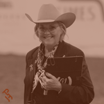 An APHA judge smiling in the arena.