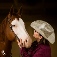 A backdrop photo of an owner and their horse.