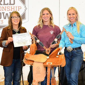 A trophy saddle being presented at World Show.