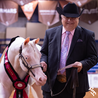 Halter Million exhibitor smiling as they exit the arena.