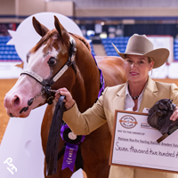 Breeders Futurity winner with their trophy and check.