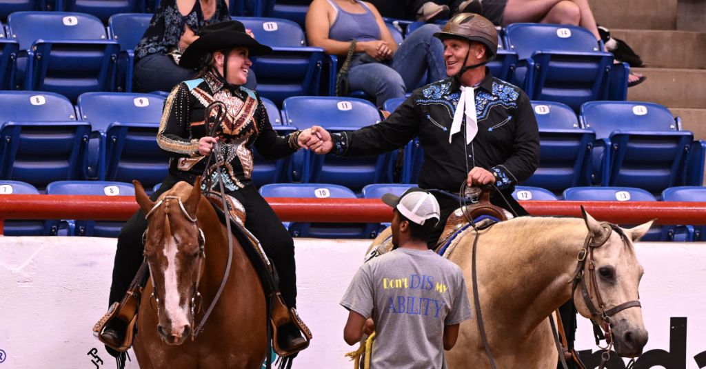 Two veterans celebrating during the Heroes on Horses class.