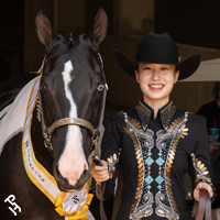 Team China member smiling with their horse.