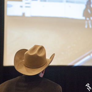 A judge watching a video at a judges' seminar.