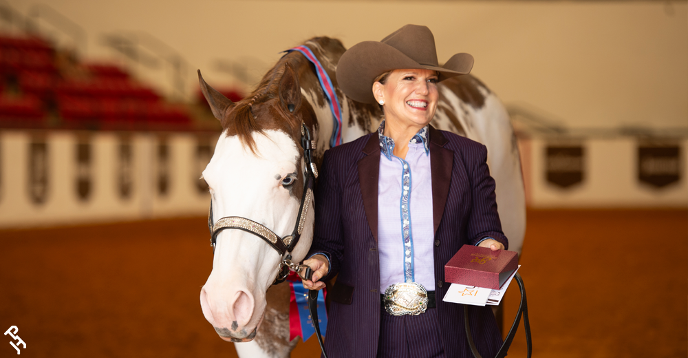 World Show champion smiling with their buckle.