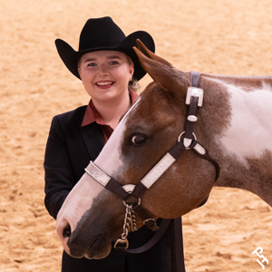 A youth member smiling in the arena.