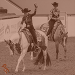 Exhibitor showing off their champion buckle at World Show.