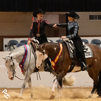 Two youth celebrating their wins in the show arena.