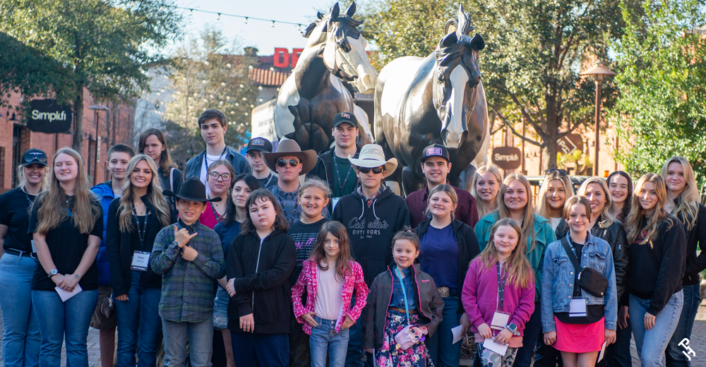 Youth Leadership Gathering group photo in front of the bronzes.