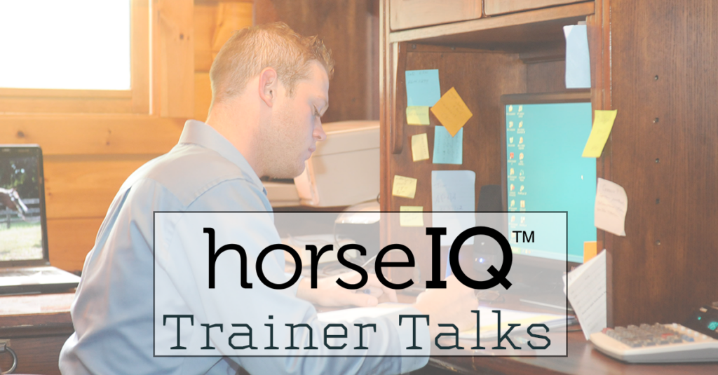 Trainer working in their office with the horseIQ logo.