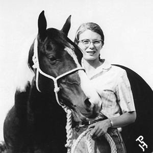 APHA founder Rebecca Tyler Lockhart standing beside a Paint Horse in a historic black-and-white photo